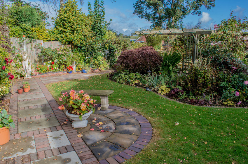 Beautiful Garden, Staffordshire, England, with established and well stocked borders, a wide variety of plants, and neatly kept patio and lawns.